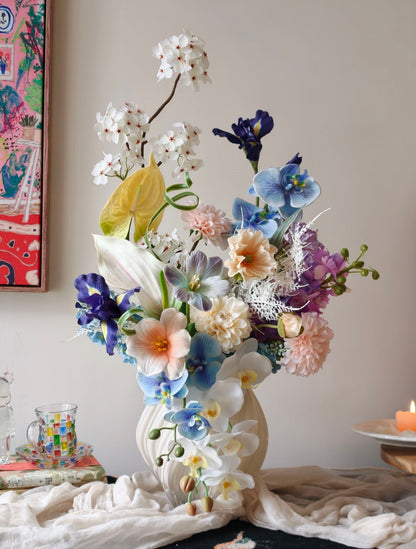 Luxury faux flower bouquet in white sculptural vase - front view