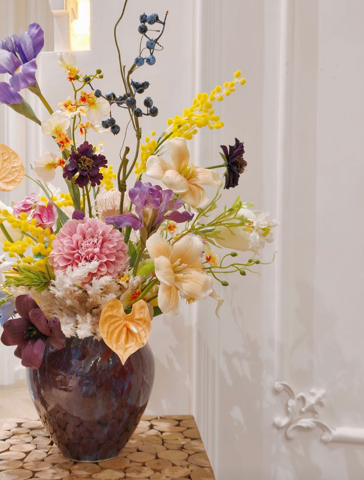 Wild meadow faux flower bouquet in deep blue ceramic vase - front view
