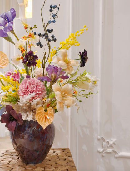 Wild meadow faux flower bouquet in deep blue ceramic vase - front view