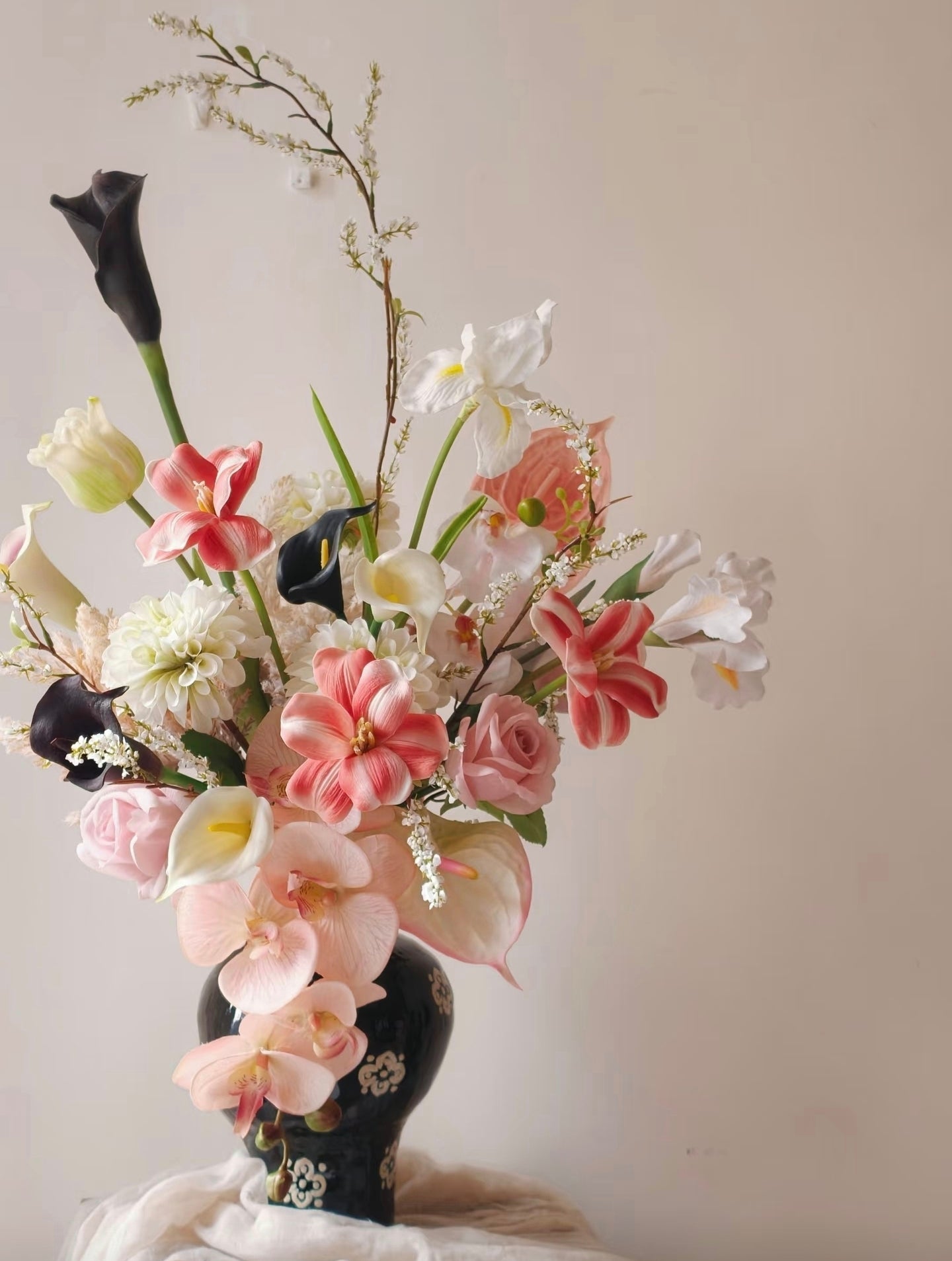Ink & Petal bouquet in natural light on woven side table