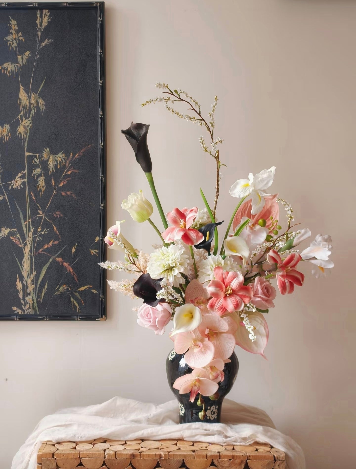 Ink & Petal bouquet styled with dark botanical art print backdrop