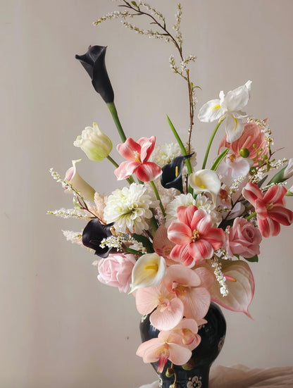 Ink & Petal bouquet with black calla lilies and blush blooms in black ceramic vase - close up