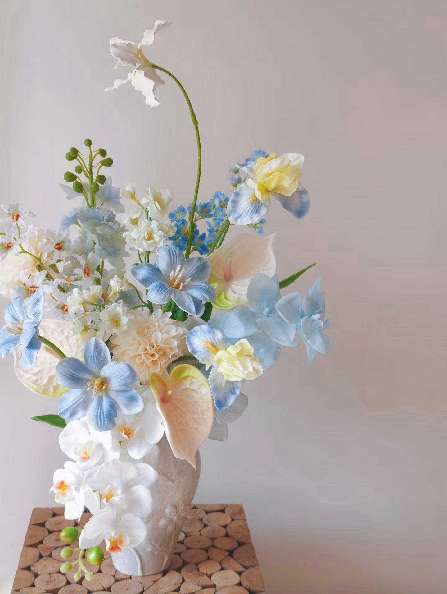 Cloud & Petal bouquet in sculptural ivory ceramic vase - front view on linen cloth