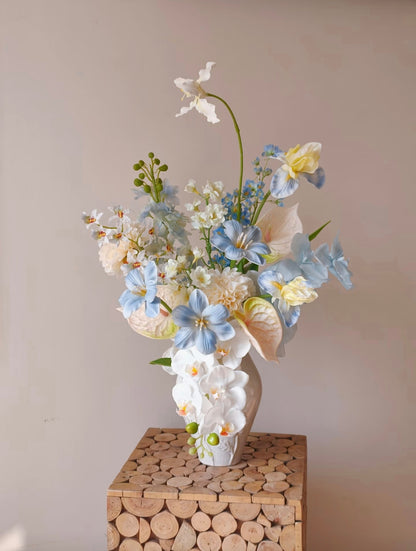 Cloud & Petal bouquet on wooden block pedestal - full arrangement view