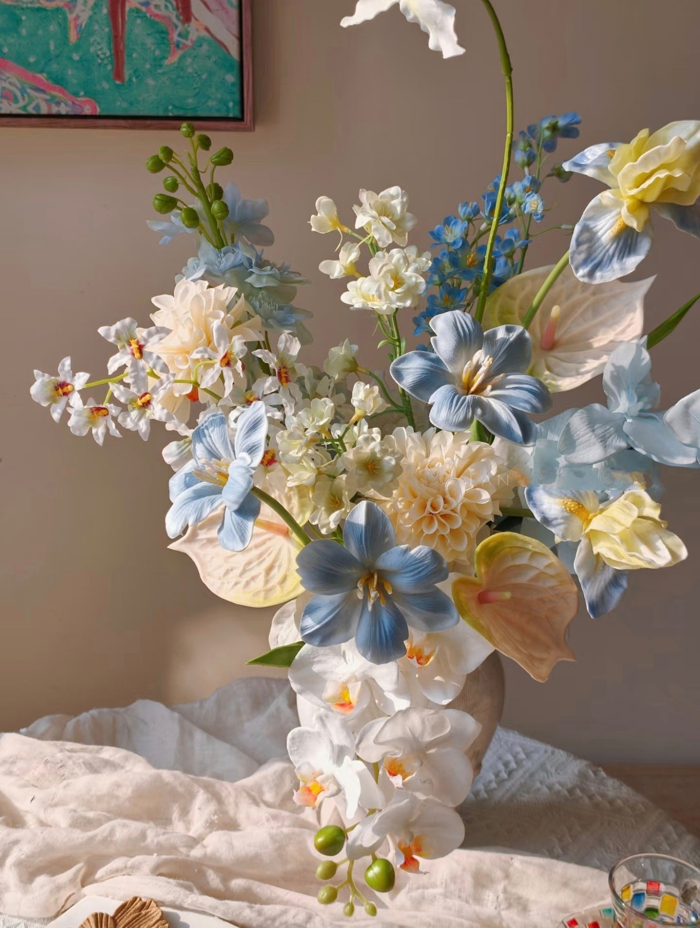 Cloud & Petal bouquet on white plaster pedestal - clean background