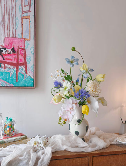 The Painter's Garden bouquet - close up of yellow tulips, blue clematis and blush orchids