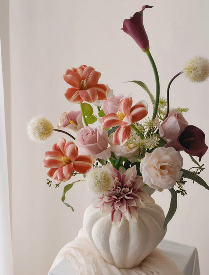 Dusk & Dahlia bouquet in ribbed ivory ceramic vase - front view on draped white table