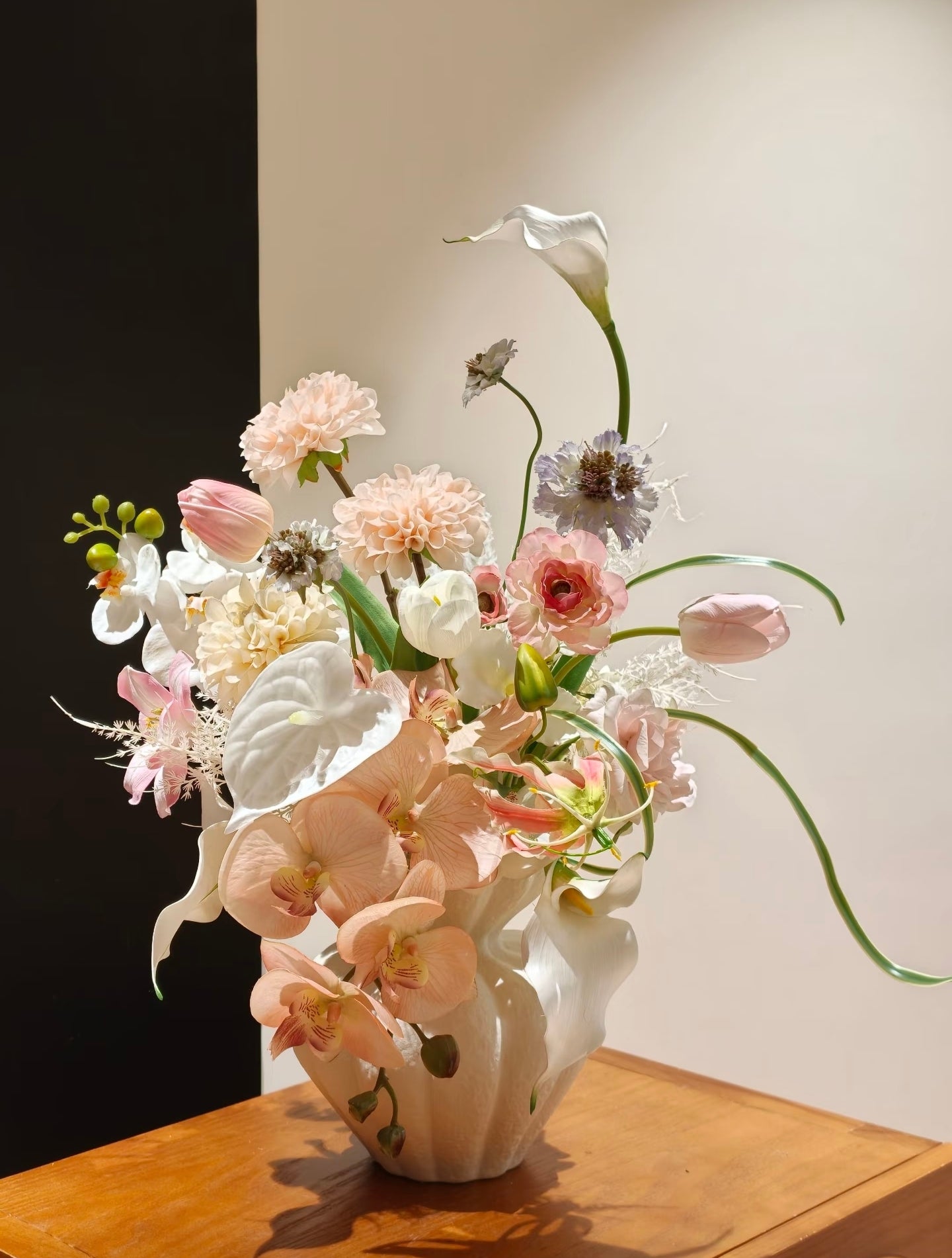 Porcelain Dream bouquet - side angle showing white calla lily arch and blush orchid cascade