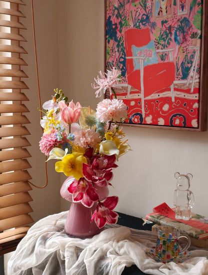 Wild & Wonderful bouquet in garden globe vase with art print backdrop - front view