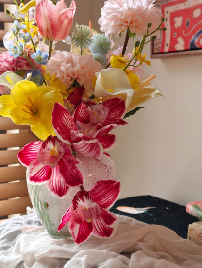Wild & Wonderful bouquet in garden globe vase - side angle with wooden blind backdrop