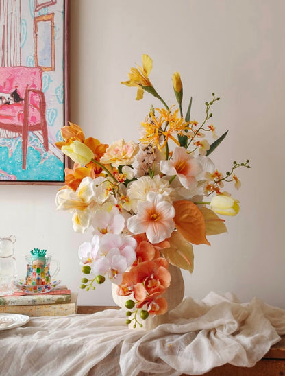 Golden Hour bouquet - close up of peach orchids, orange anthurium leaves and cream dahlias